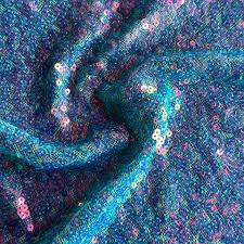 Sequin fabric is a type of textile embellished with small, shiny discs, known as sequins, which are often made from plastic or metal.