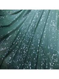 Sequin fabric is a type of textile embellished with small, shiny discs, known as sequins, which are often made from plastic or metal.